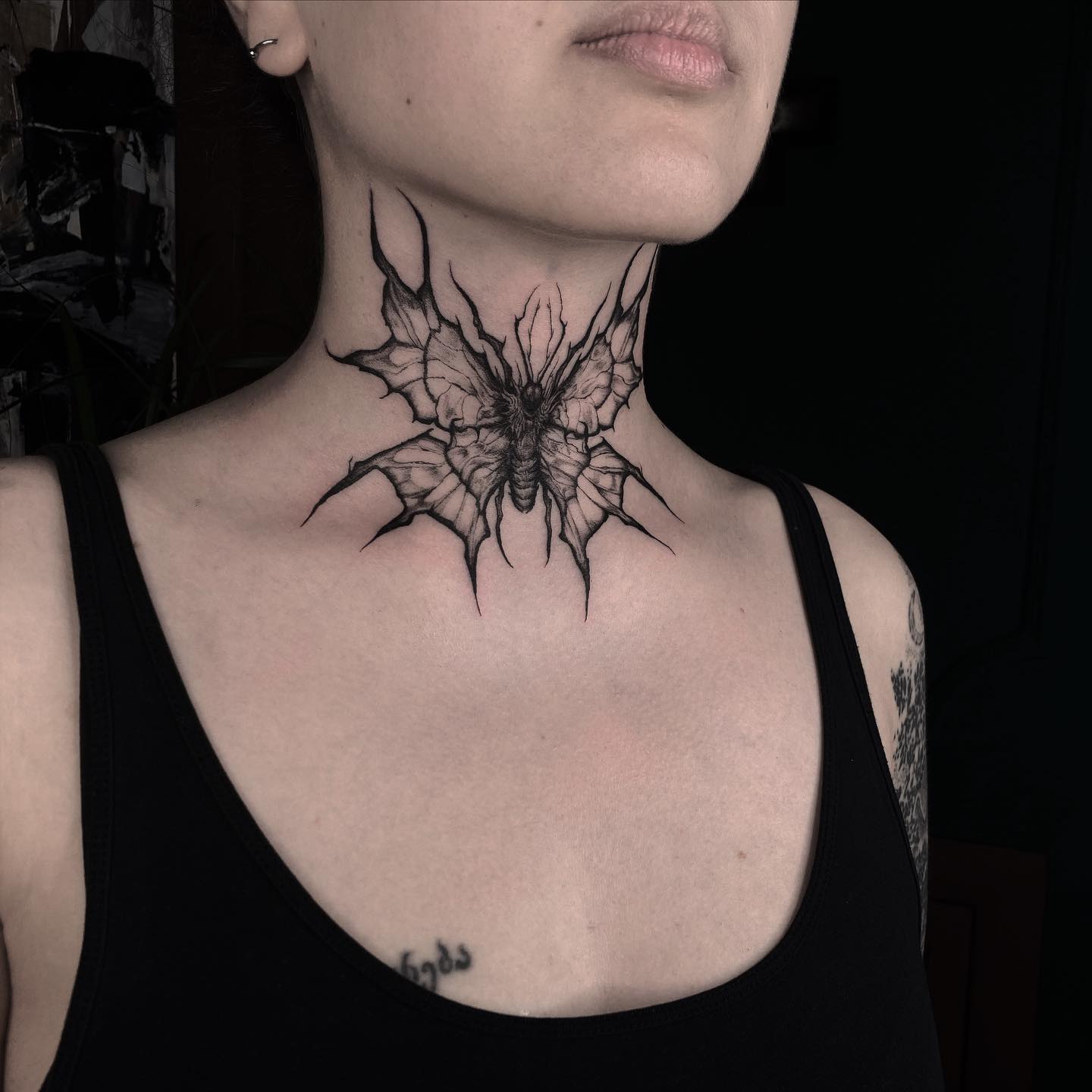 Moth tattoo on neck by nekropsy