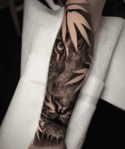 Realistic tiger tattoo on lower arm by inmacalero.tattoo