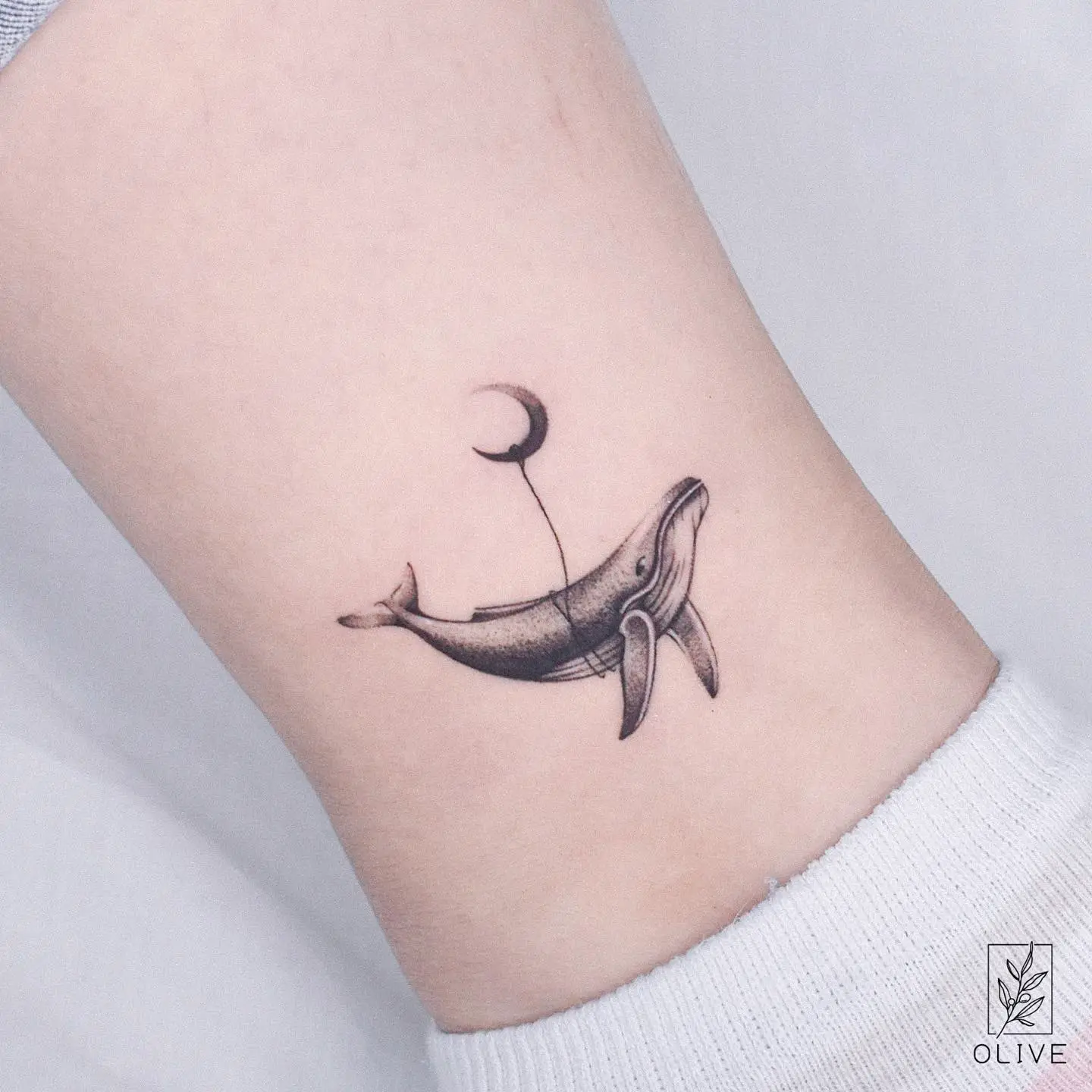 Simple whale tattoo by tattoo artist olive