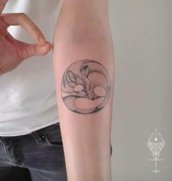 Sleeping fox tattoo on lower arm 2