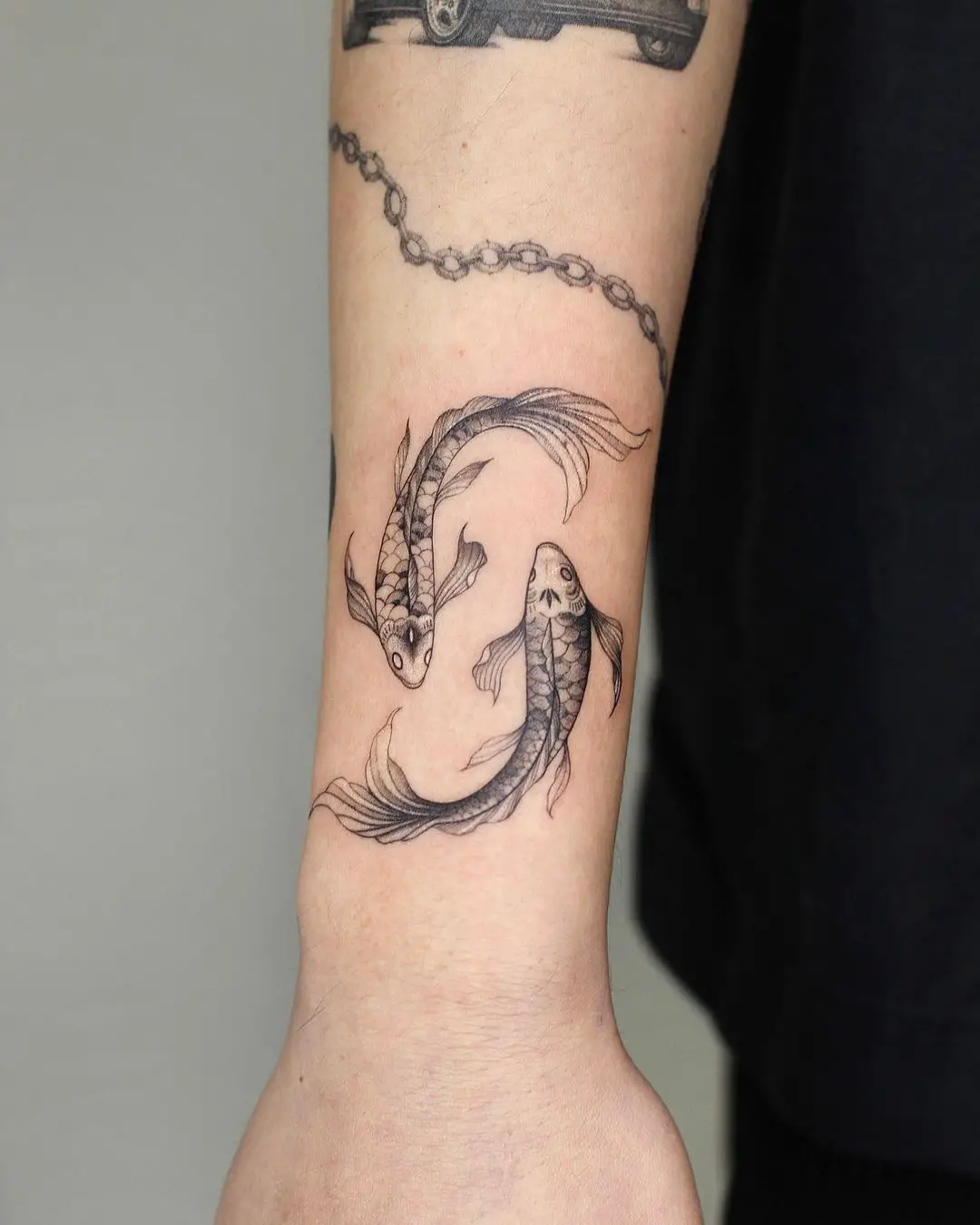 Two fish tattoo by linsey tattooer