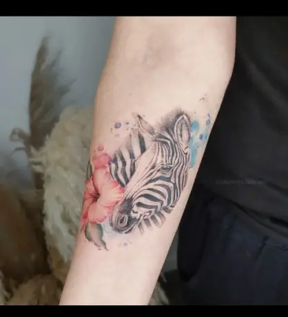 Zebra with flower tattoo by jackemichaelsen.tattoo