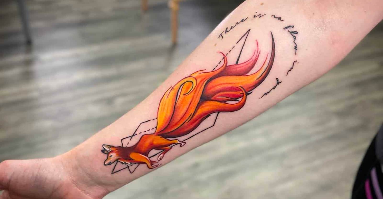 watercolor fox tattoo on the lower arm