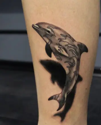 Black and gray dolphin tattoo by guzeev.tattoo