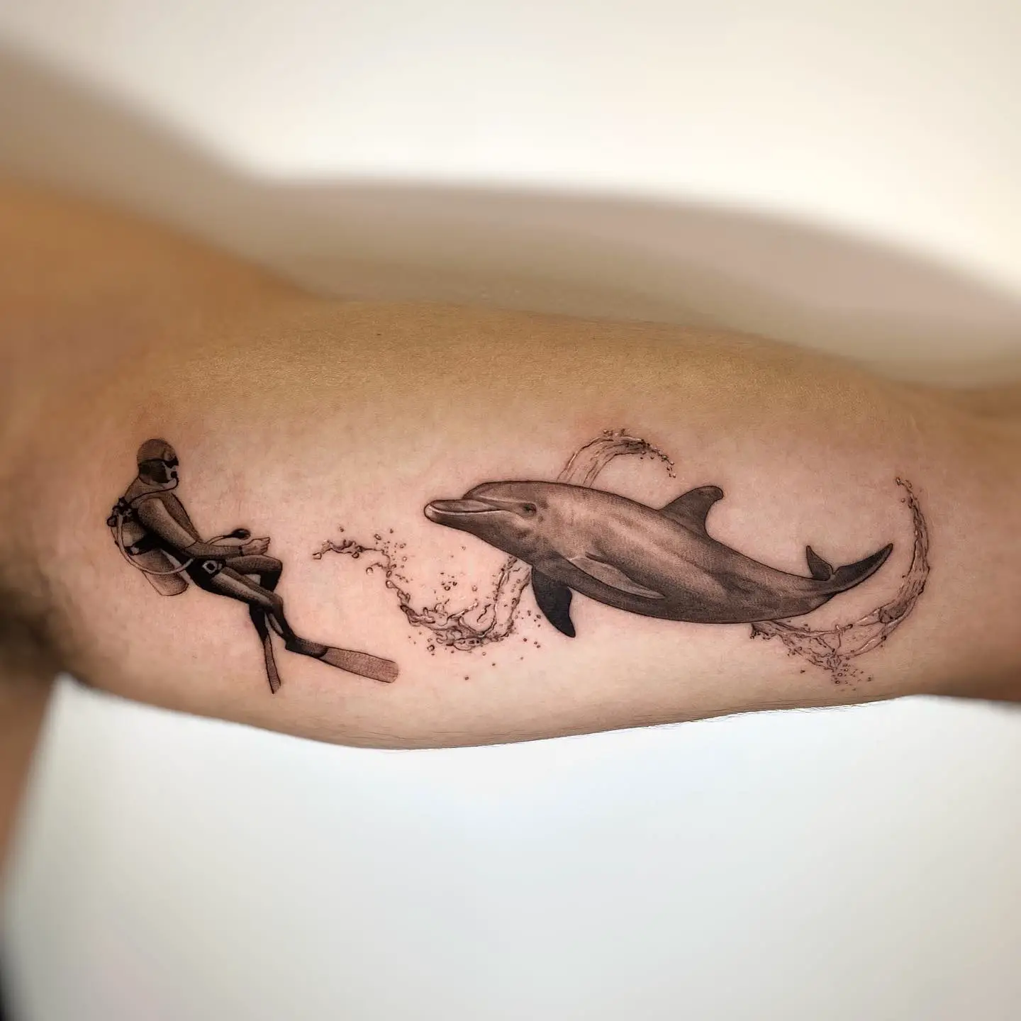 Black and gray dolphin tattoos by mogiz.tattoo