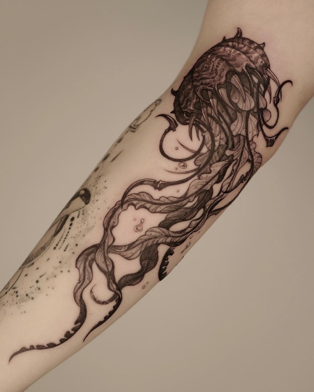 White ink jellyfish tattoo on the left calf