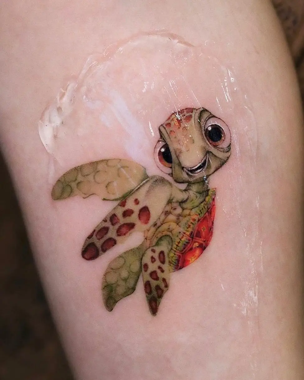 Cartoon style turtle tattoo by obessiontattoovalencia