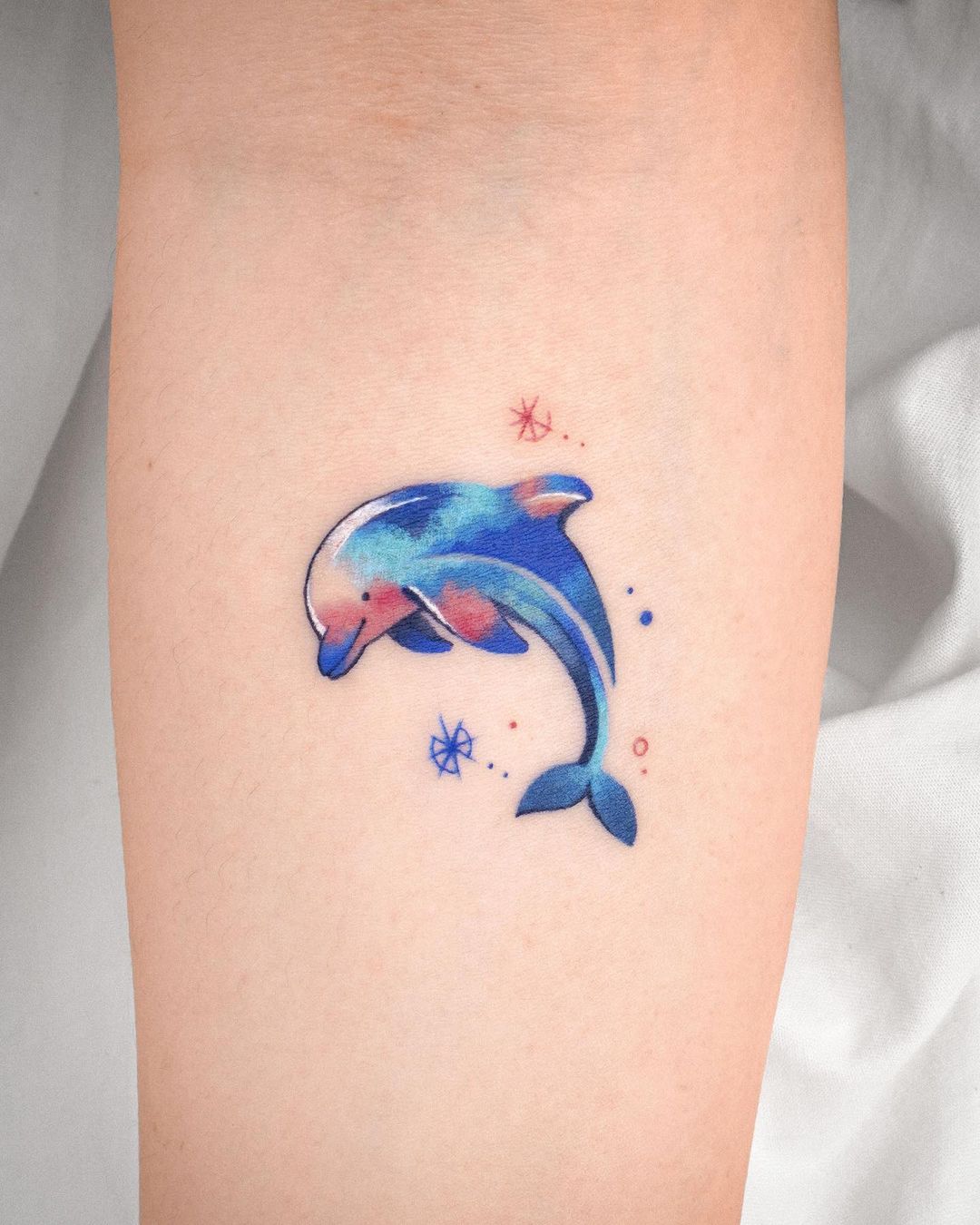 Dolphin tattoo by eden tattoo