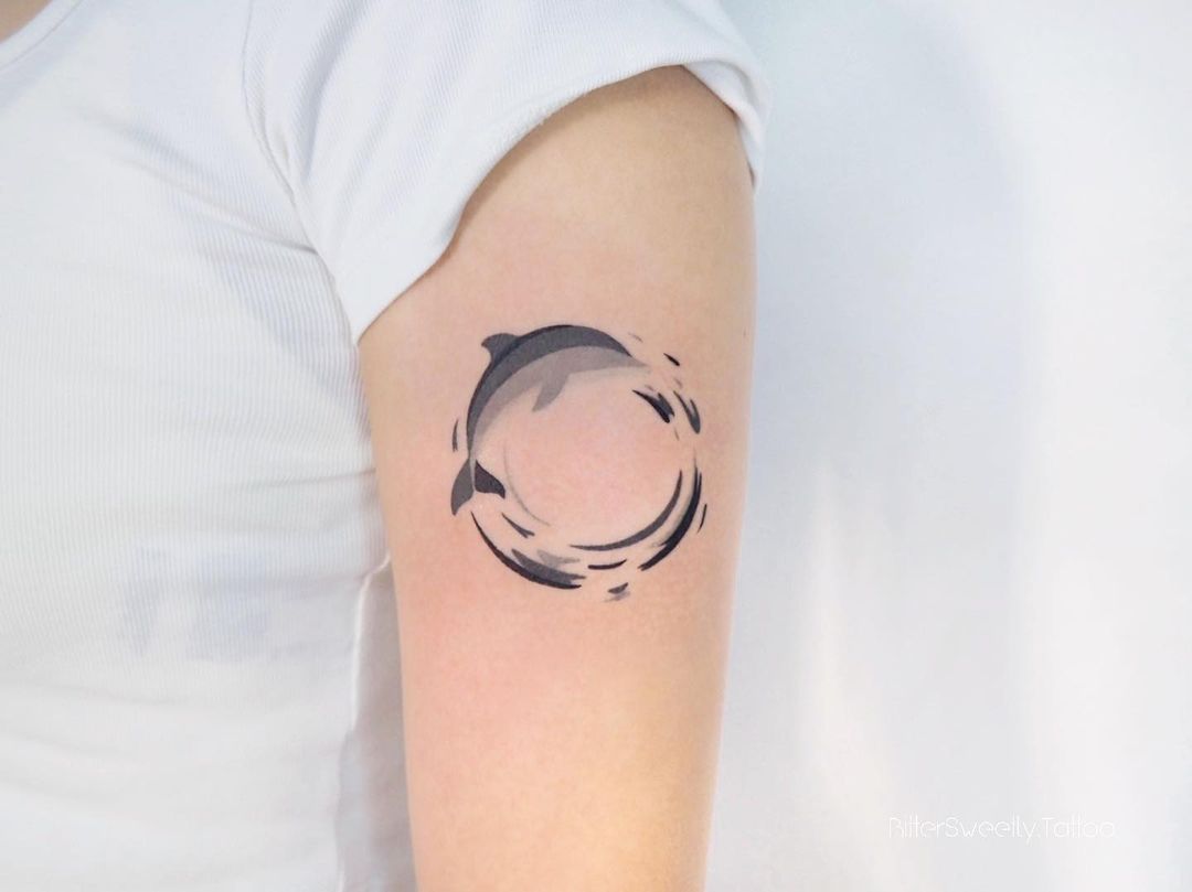 Dolphin tattoo on upper arm by bittersweetly.tattoo