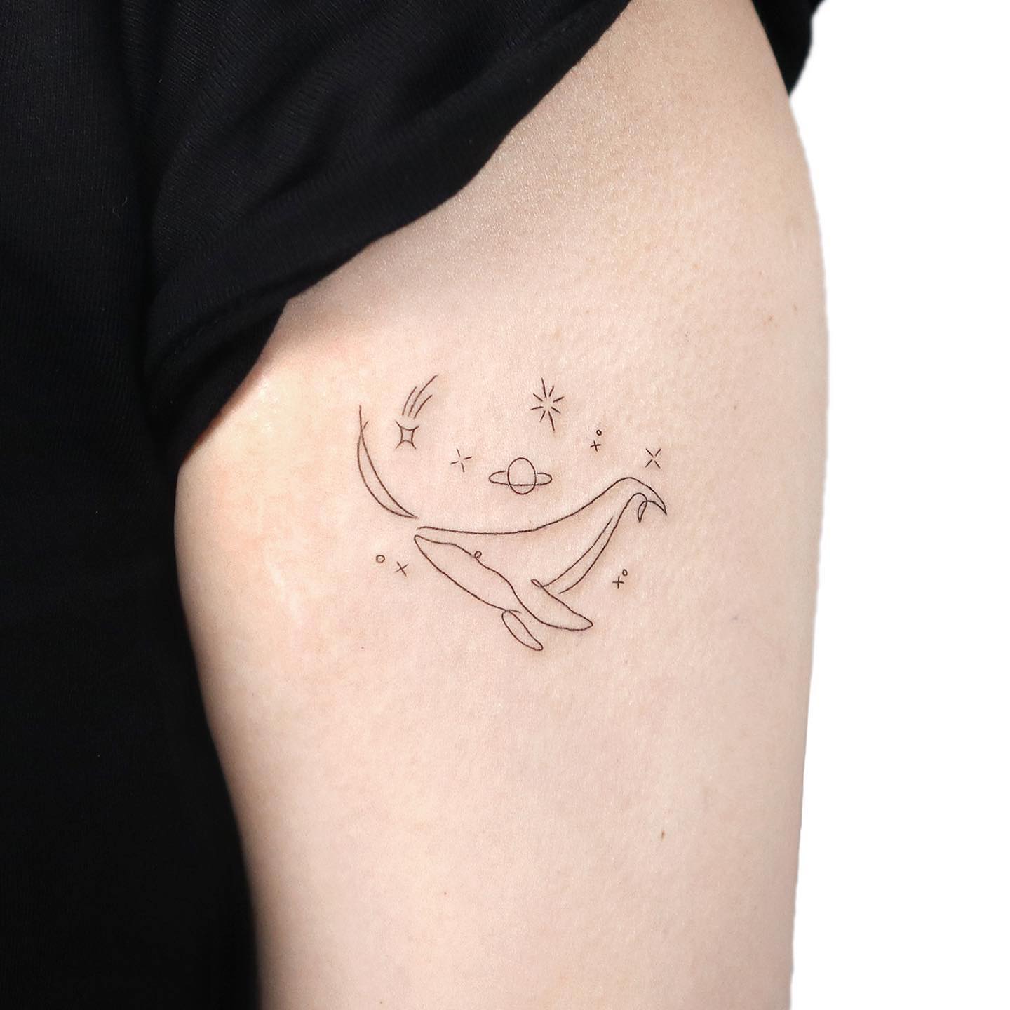 Dolphin tattoo on upper arm by gigi tattooer