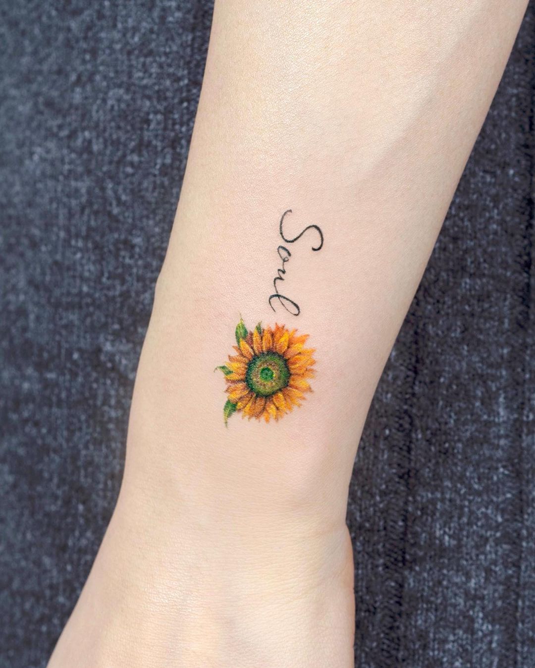 Minimalist sunflower tattoo by tilda tattoo