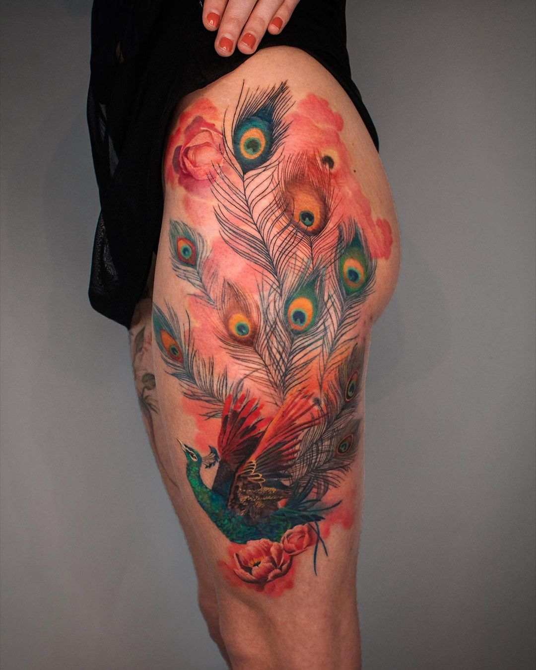Peacock tattoo on thigh by debrartist