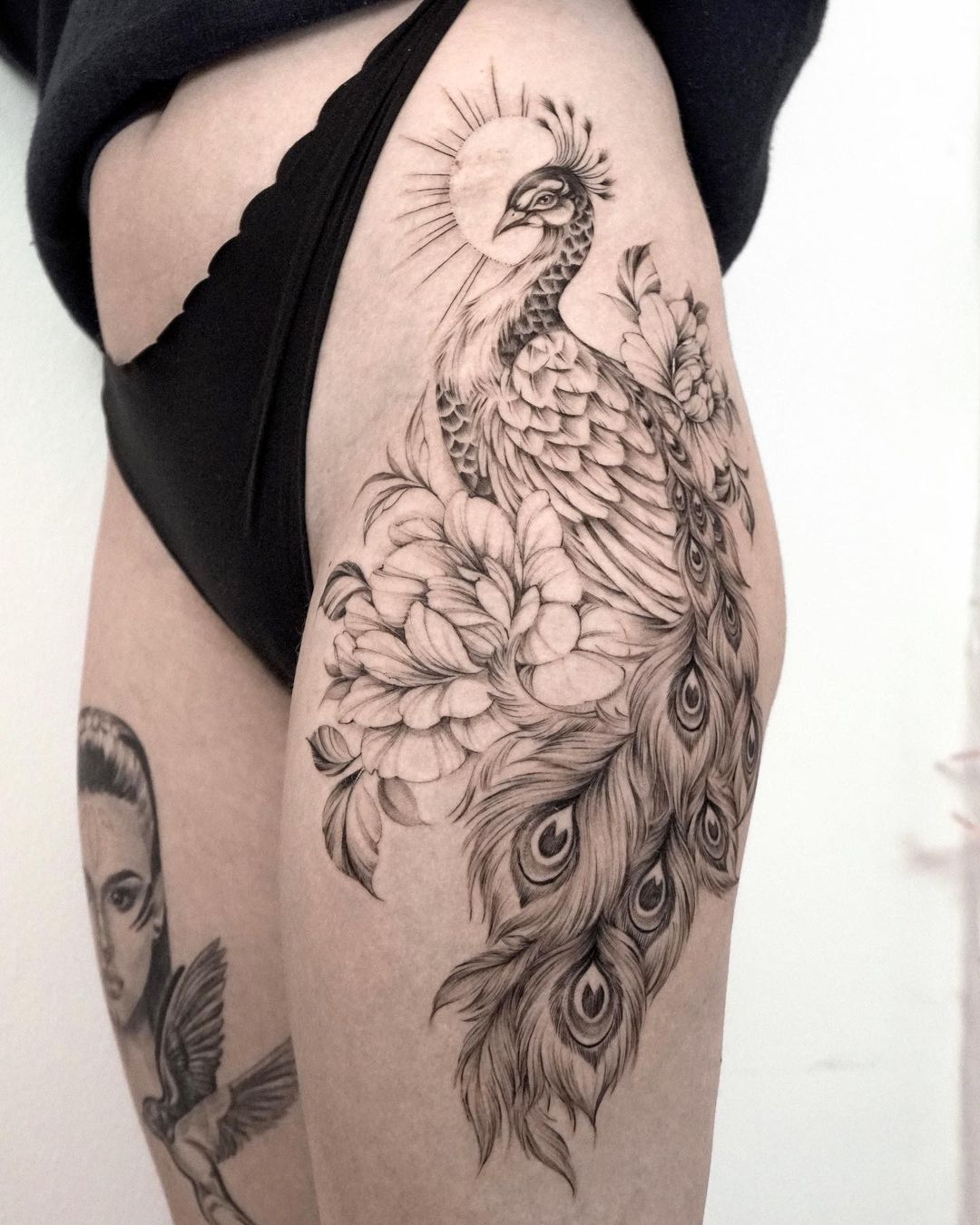 Peacock tattoo on thigh by miriamandrea.ink