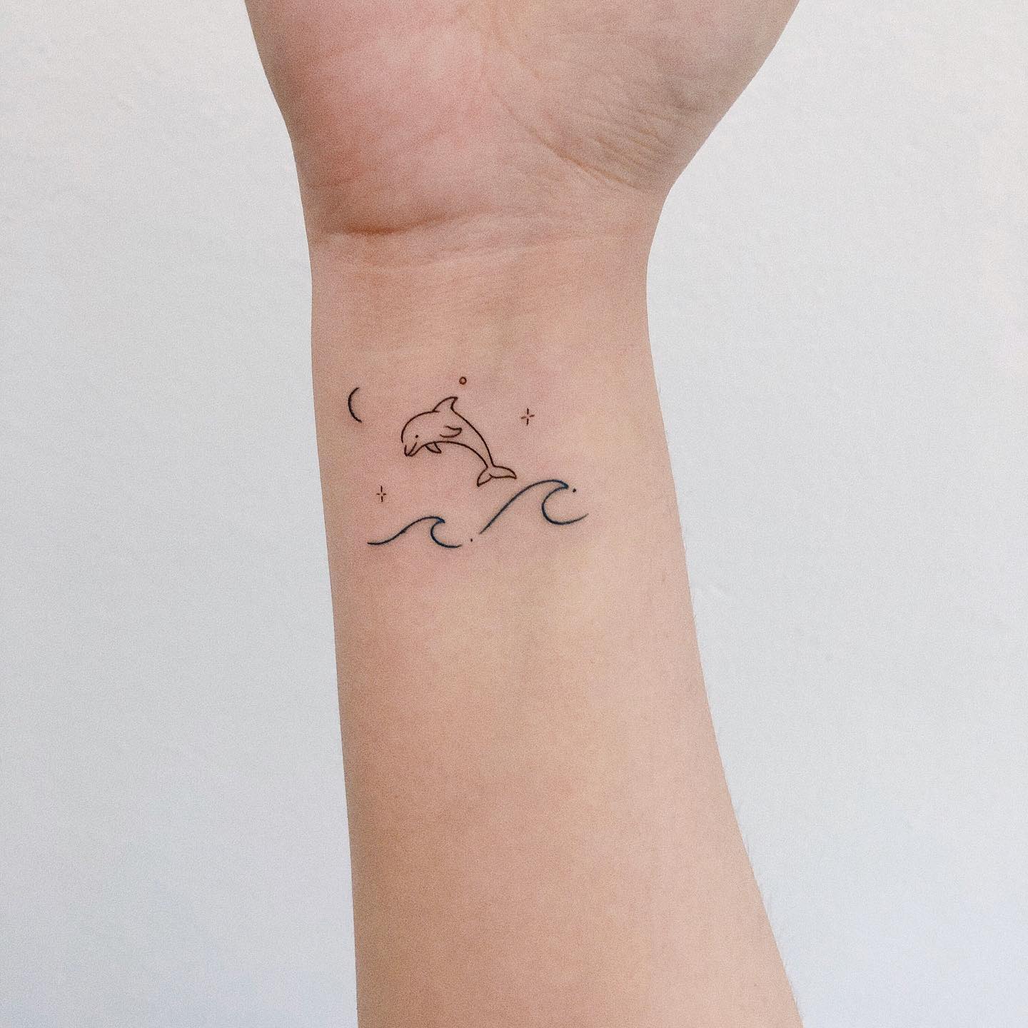 Small dolphin tattoo by rin tattooer