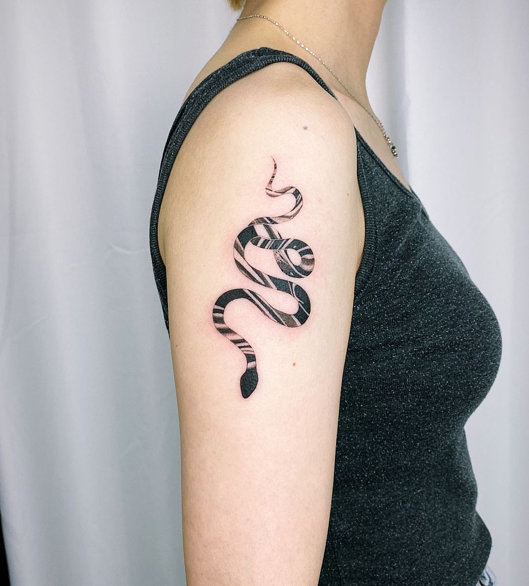 Small snake tattoo by nadoo tattoo