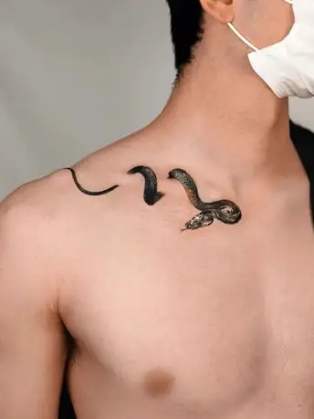 Snake tattoo on shoulder by tattoohelps