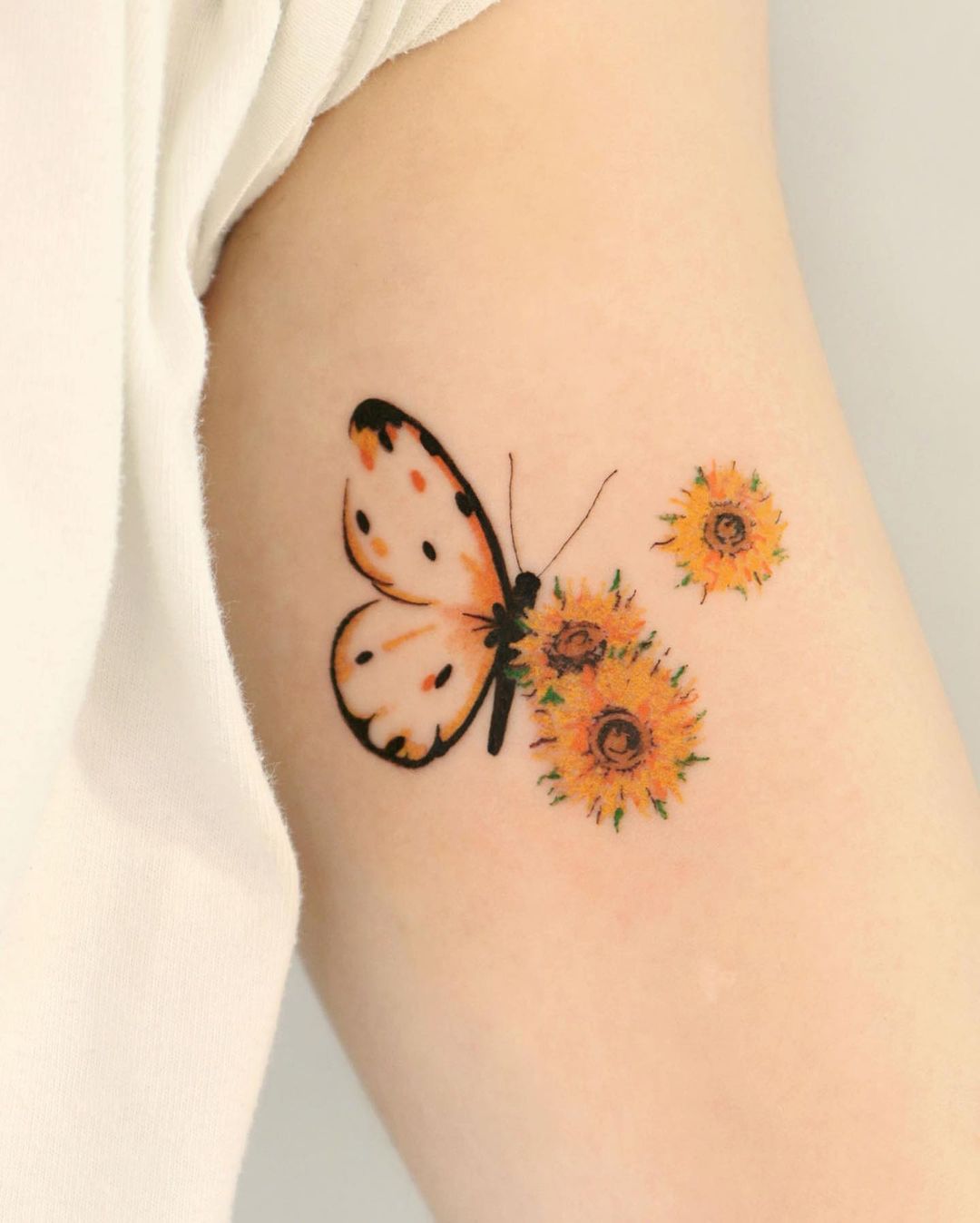Sunflower with butterfly tattoos by aroha tattoo