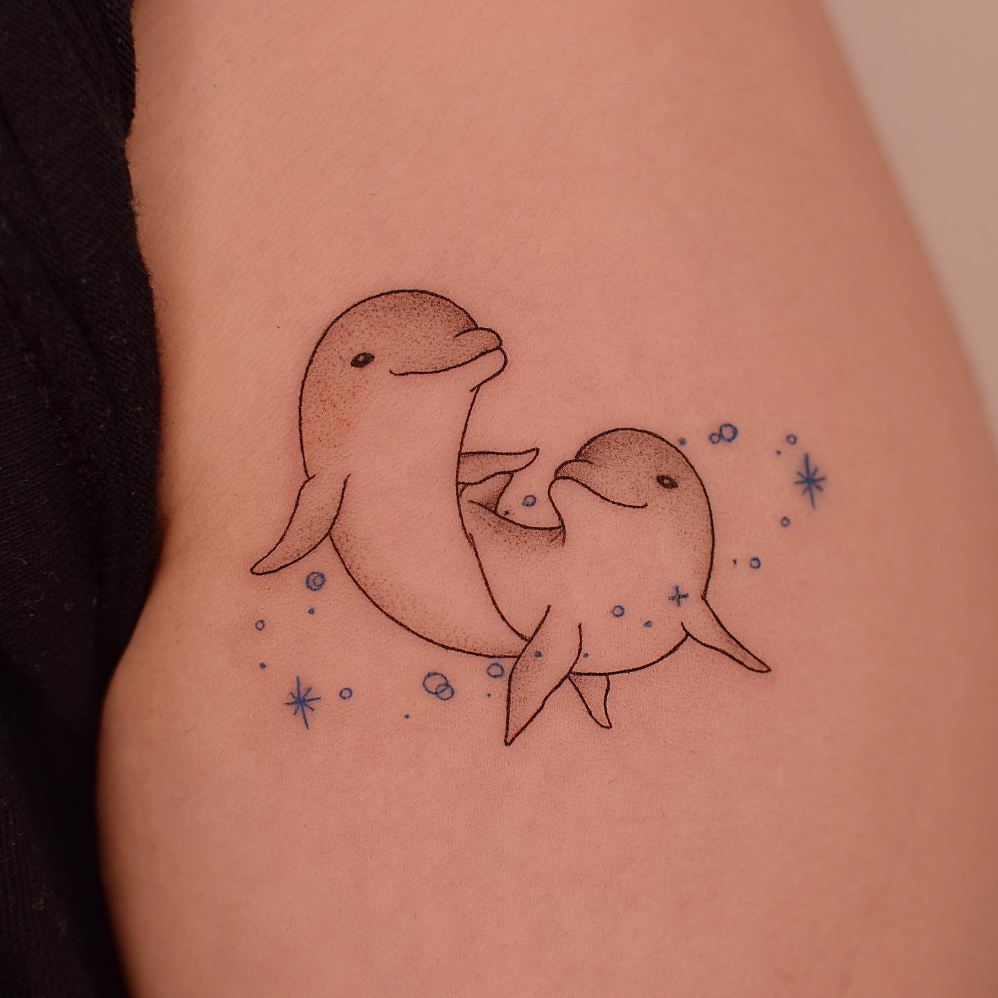 Two dolphin tattoo by tattooer jina