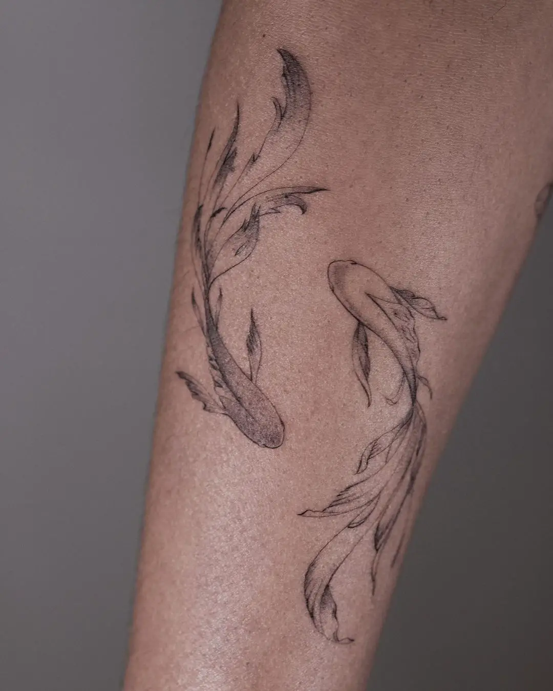 Two fish tattoo by alice adore ink