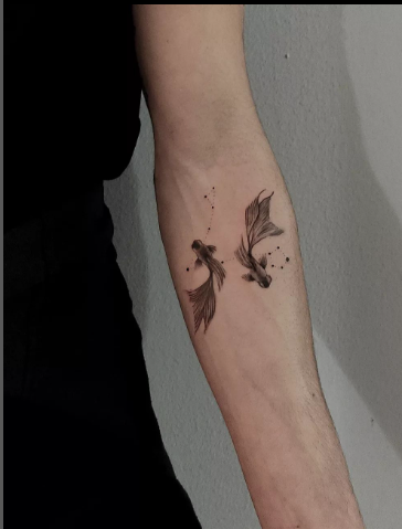 Two fish tattoo by wilja.tattoo