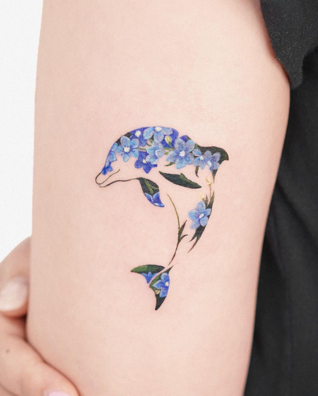 Upper arm dolphin tattoo by tattooist fluffy