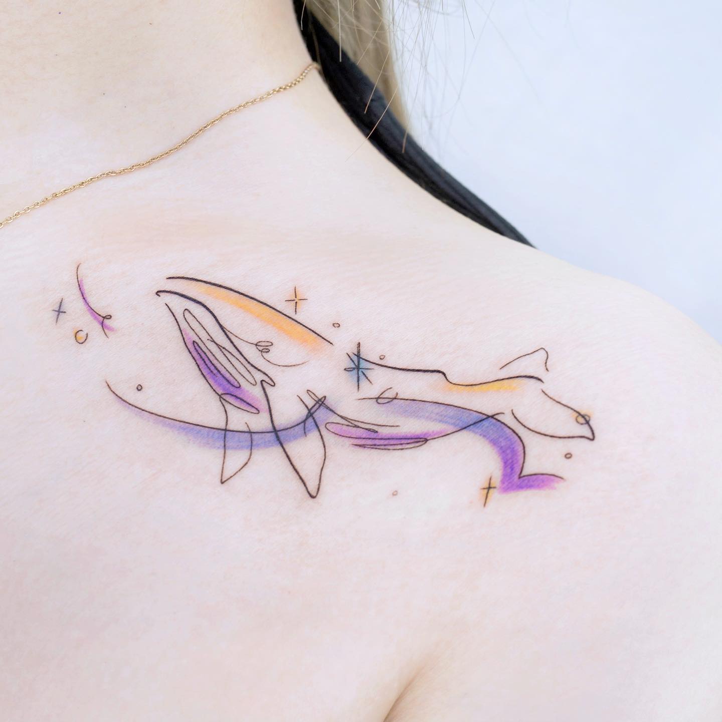 Watercolor dolphin tattoo by heim tattoo
