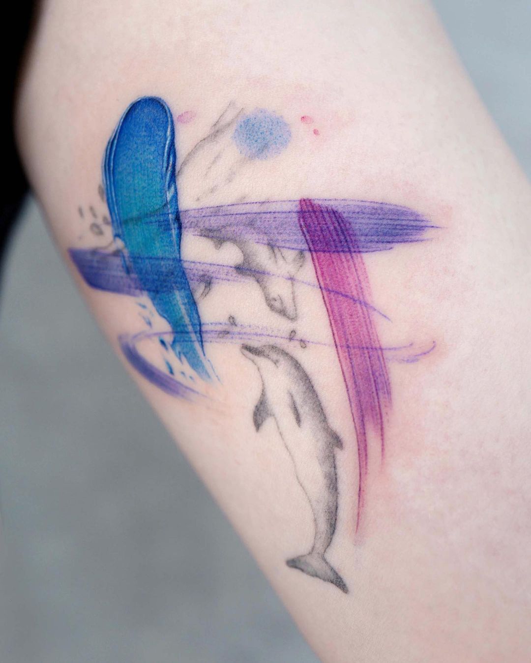 Watercolor dolphin tattoo by tattoo a piece
