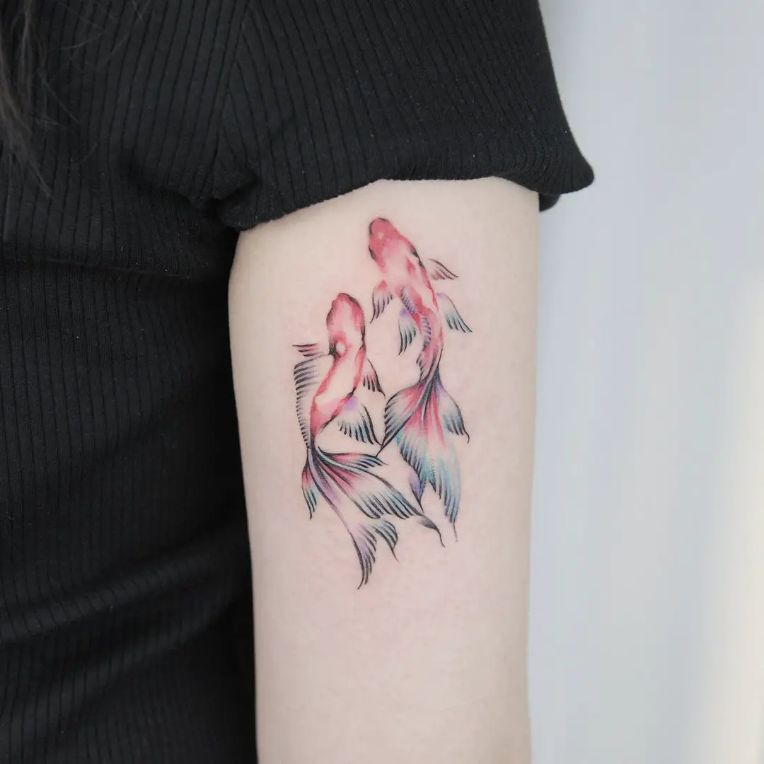 two fish tattoo by tattooist green