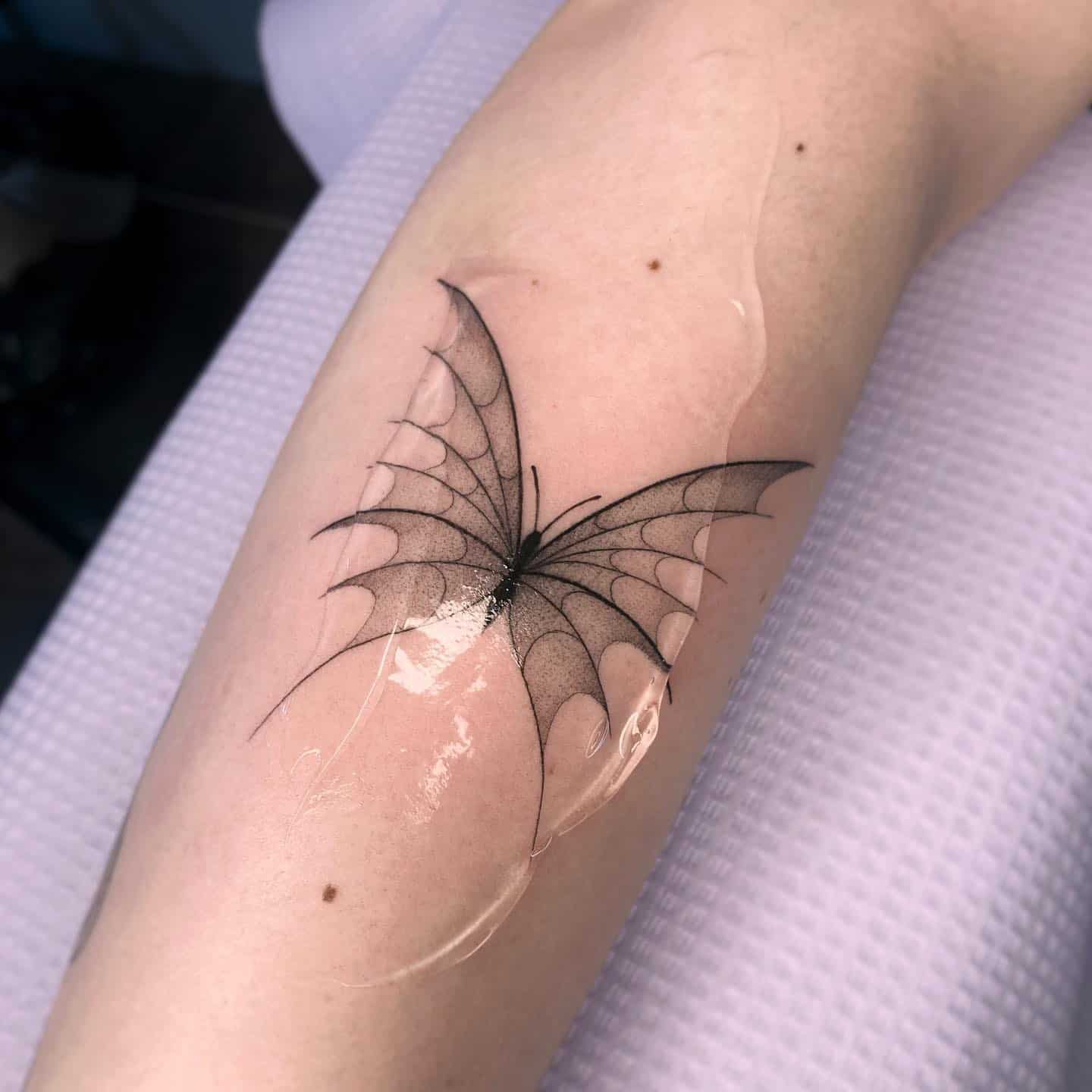 Black butterfly tattoo by koksa tattoo