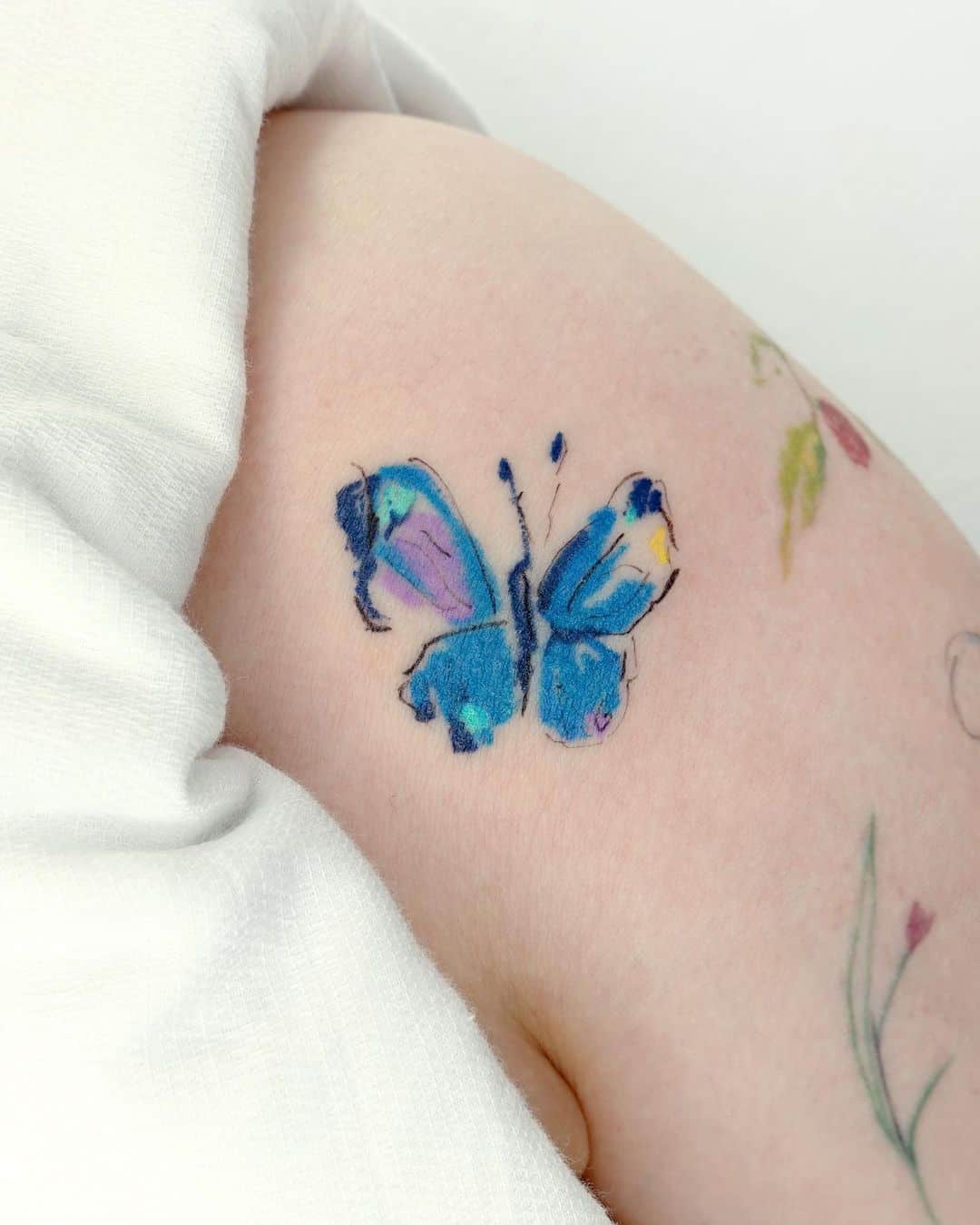 Blue butterfly tattoo by tattooist dang