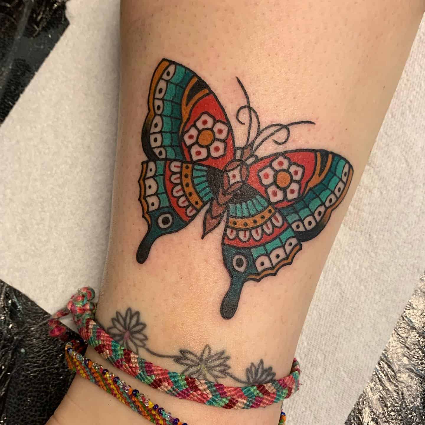Traditional butterfly tattoo by beckypopetattoo