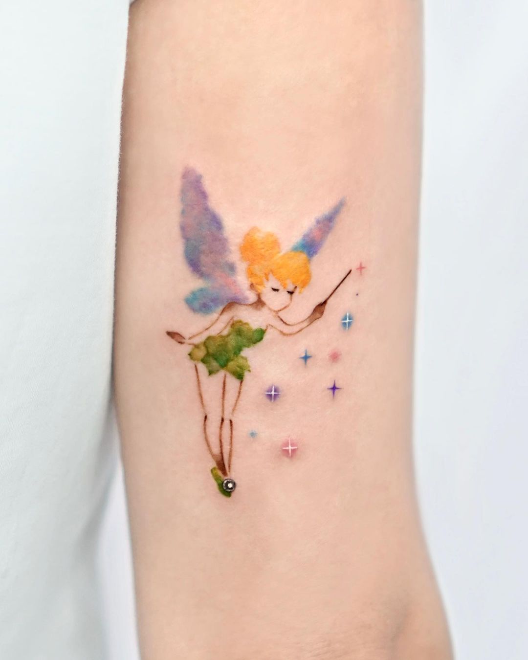 Watercolor tattoo on arm by tattooist hei