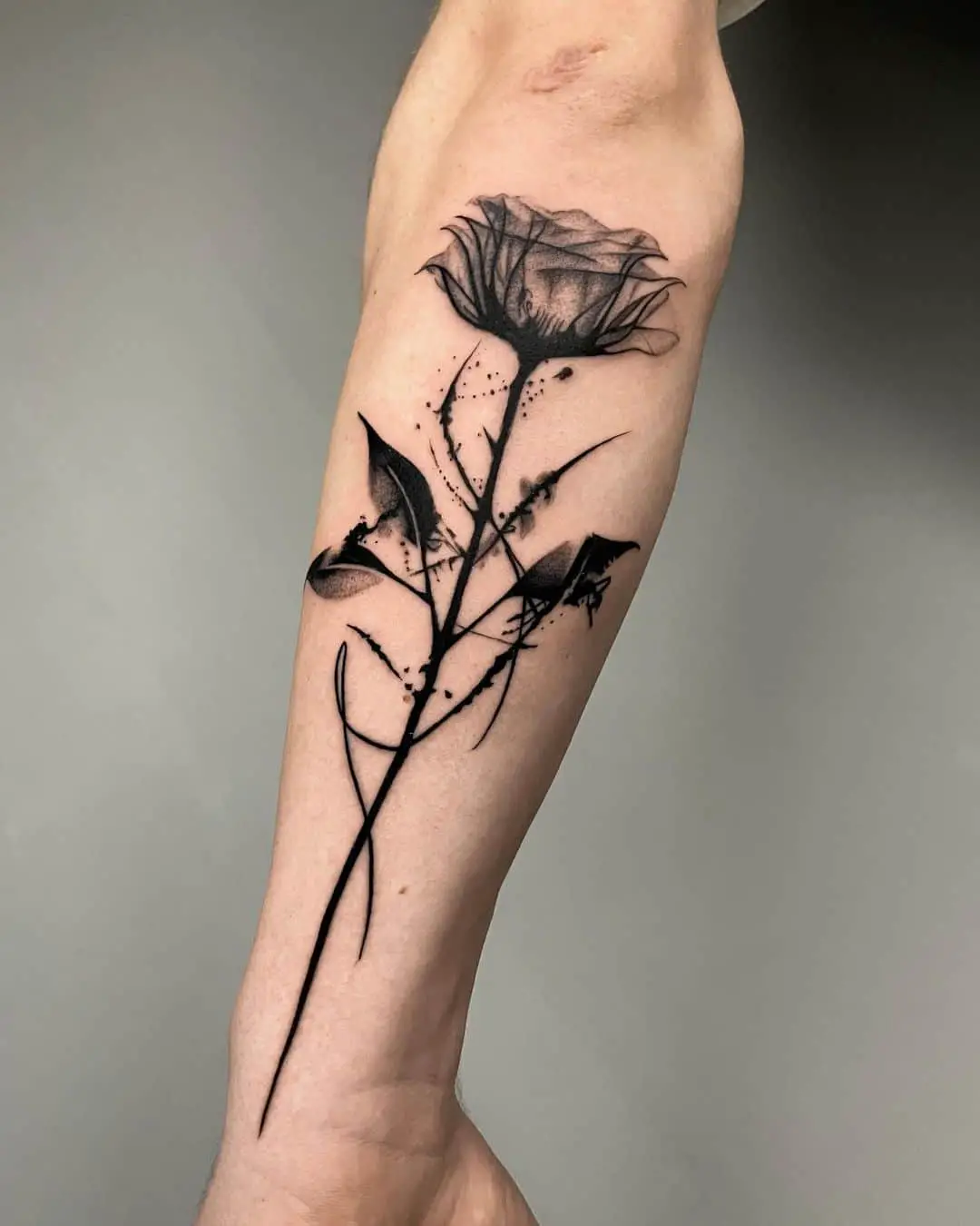 Black and grey rose tattoo by tattoo razakarian