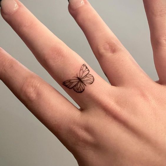 Butterfly tattoo on finger 1