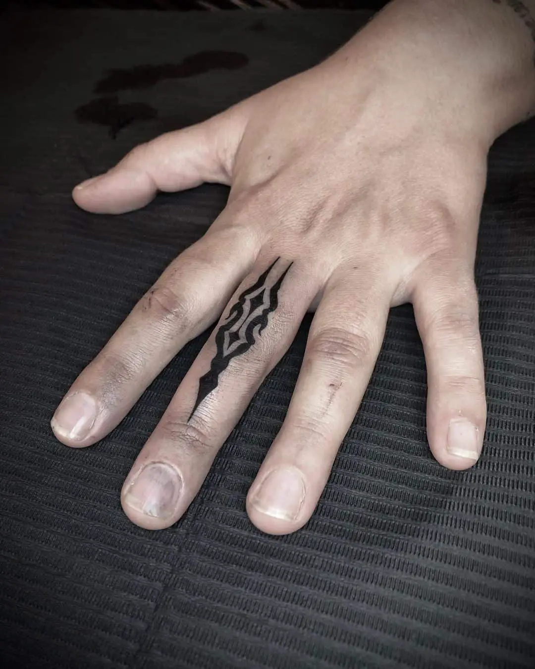 Finger tattoo for men by black wood tatooshop