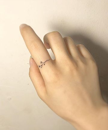 Flower tattoo on finger 3