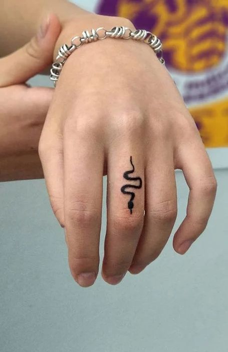 Snake tattoo on finger 1