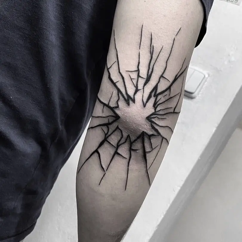broken glass tattoo on elbow by tattoo artist itsmarcelice