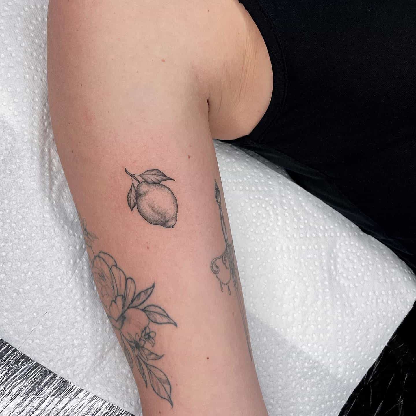 Dice tattoo located on the inner arm, minimalistic