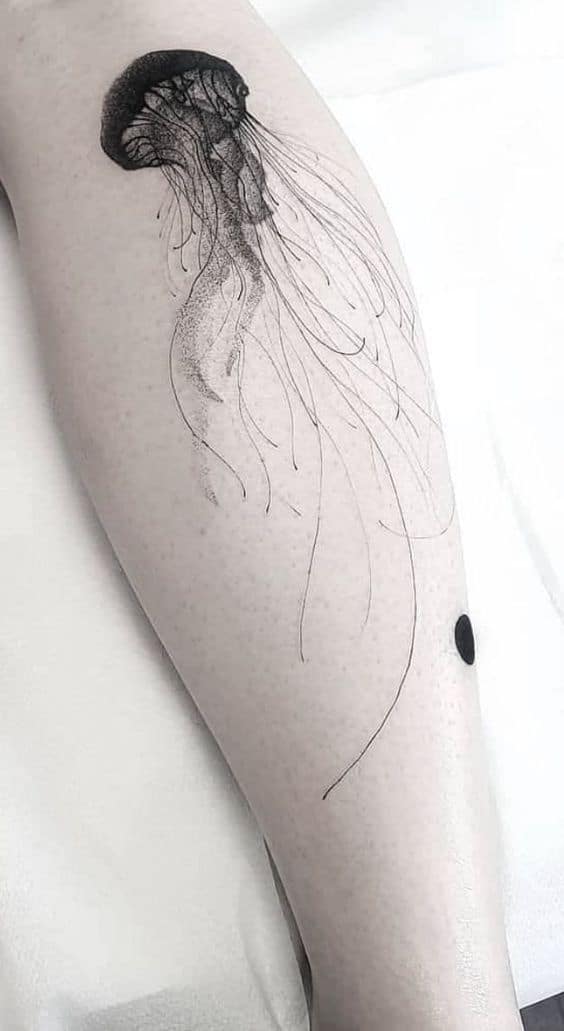 Fine line style jellyfish tattoo located on the inner