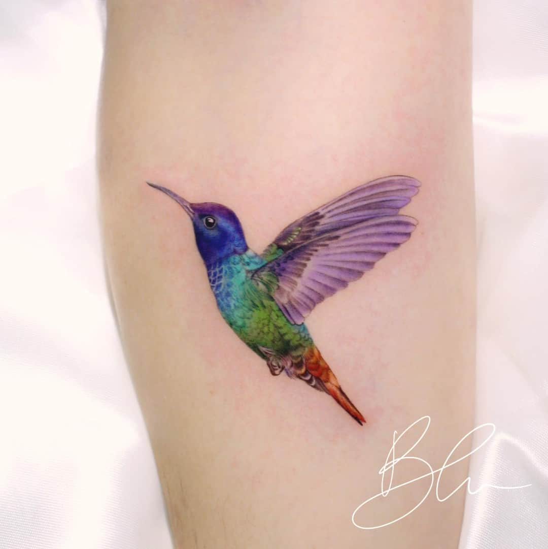 Colorful hummingbird tattoo by blu.tattoo