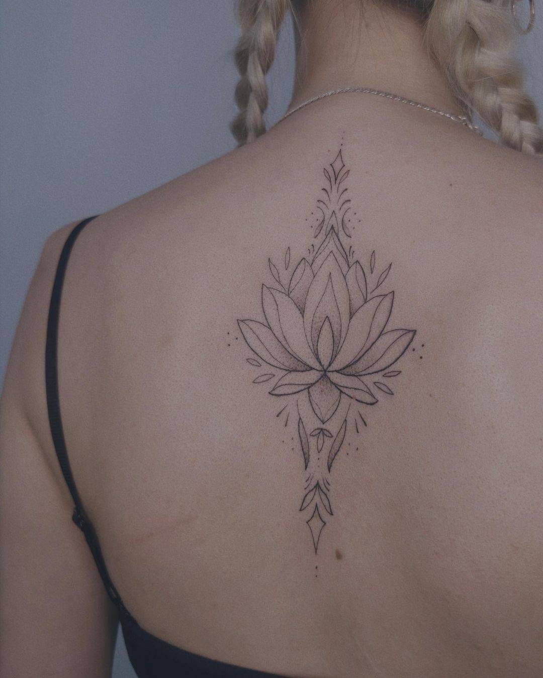 Geometric lotus tattoo by