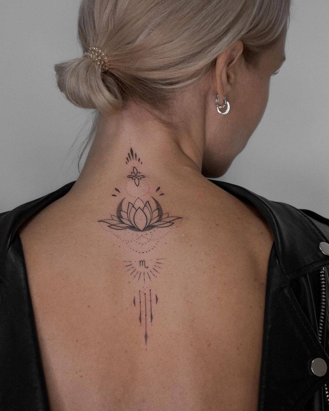Lotus tattoo on back by anylay.tattoo