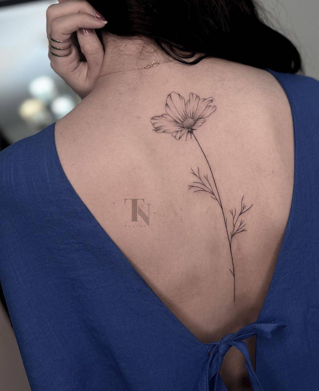 Close up of a small nightshade flower tattoo inside a circle on a back of  the neck of a woman. A delicate and feminine design. Generative AI 33340848  Stock Photo at Vecteezy