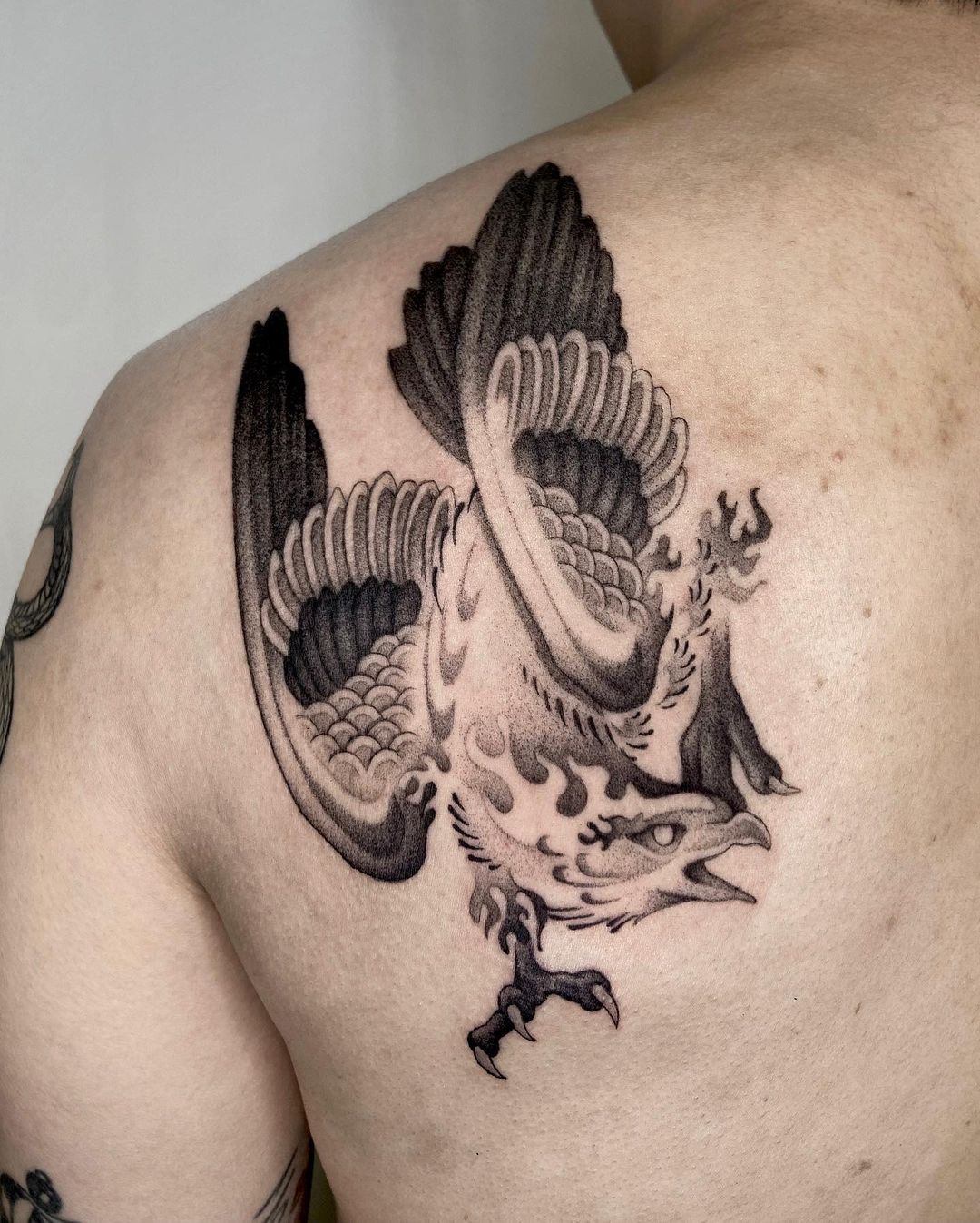 Micro-realistic falcon tattooed on the inner arm.