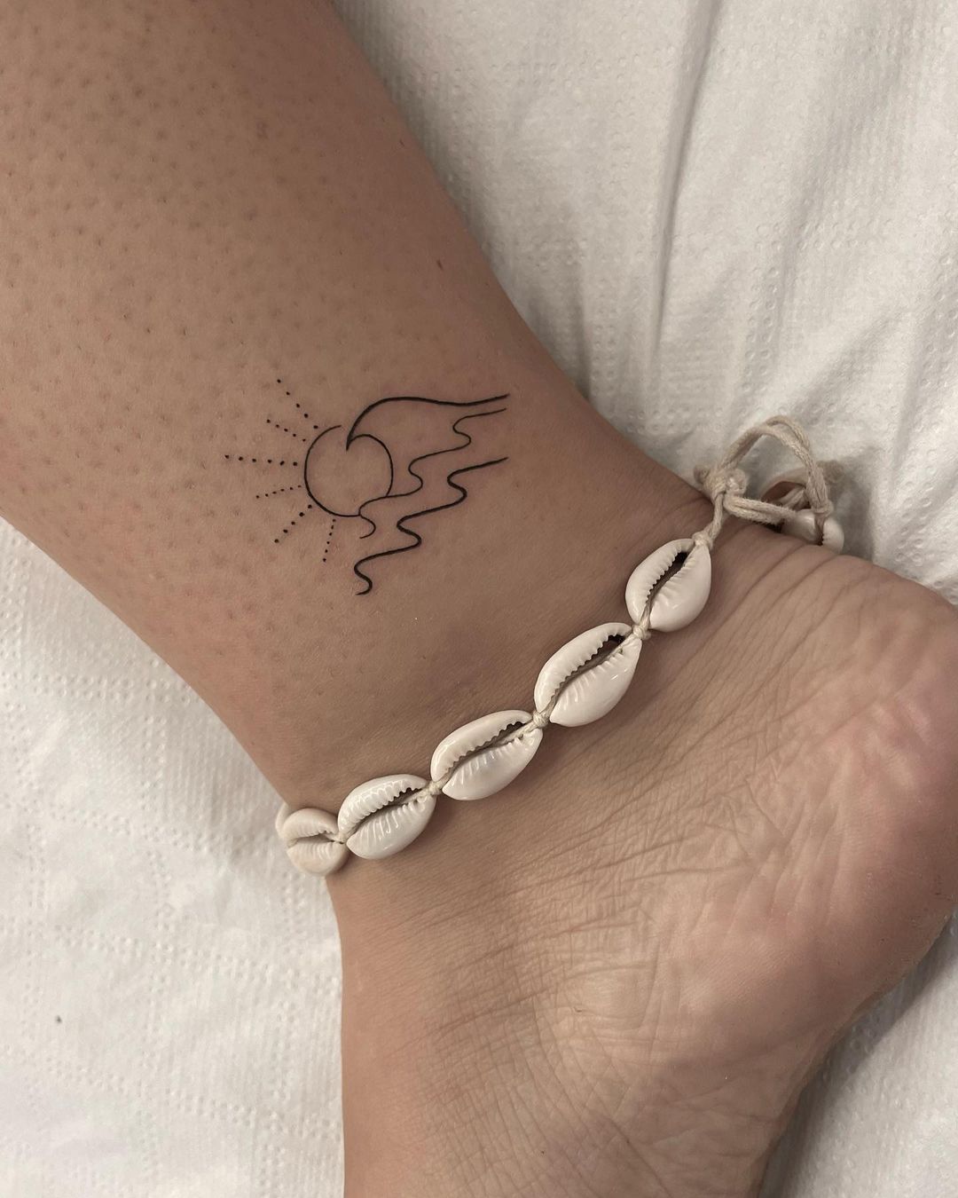 sun and waves tattoo by viburnum tattoo
