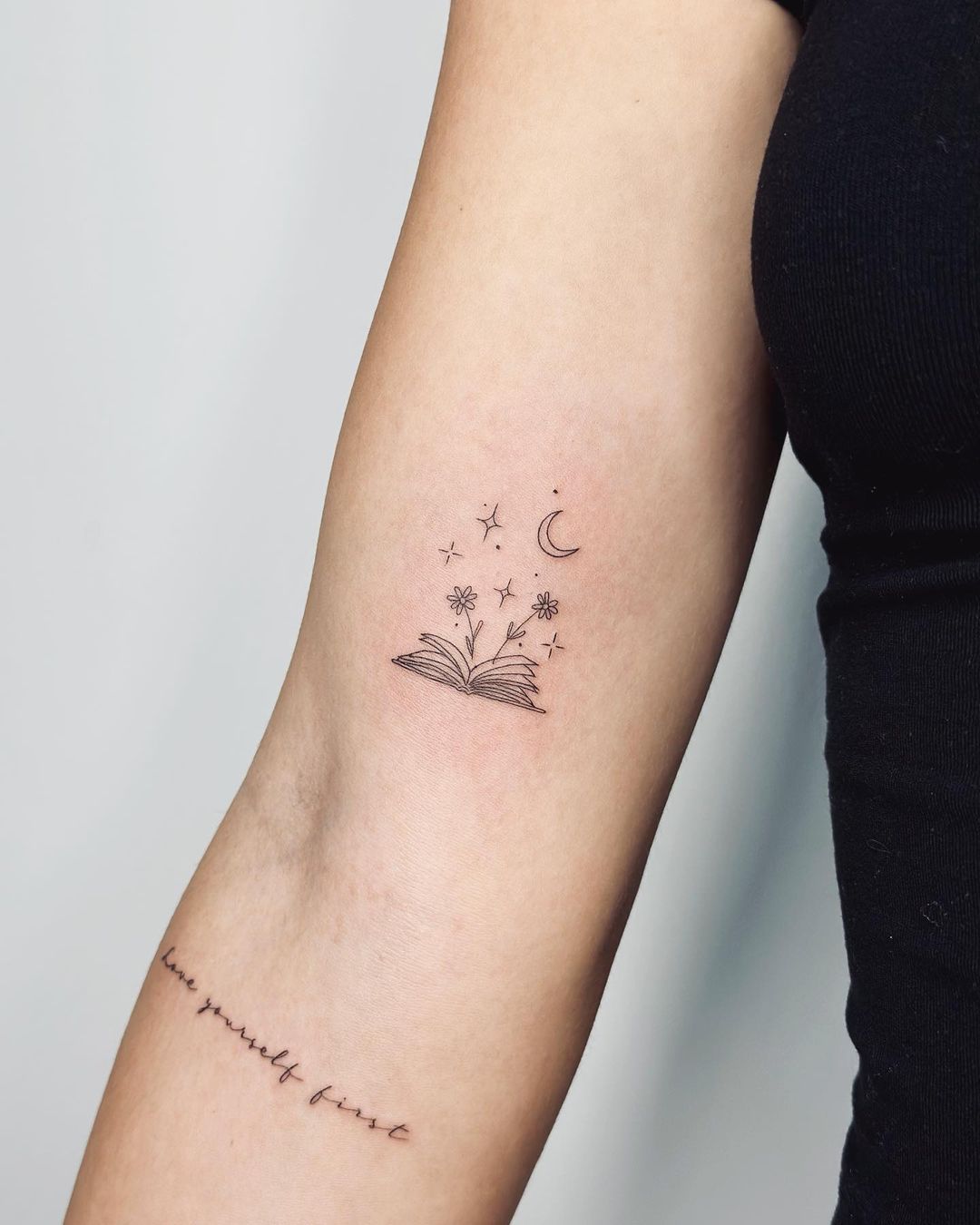 Minimalistic book tattoo by tattooing g
