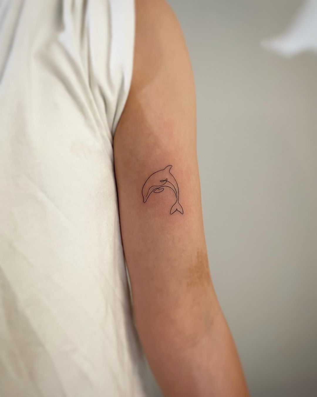 Simple dolphin tattoo by into.tattoo