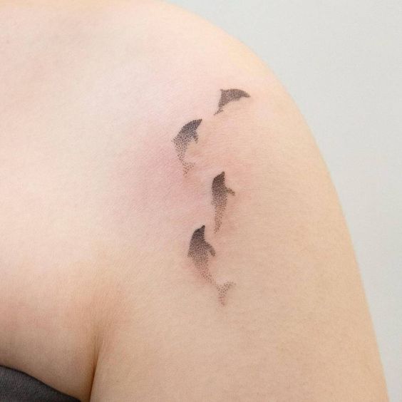beautiful multiple dolphin tattoo