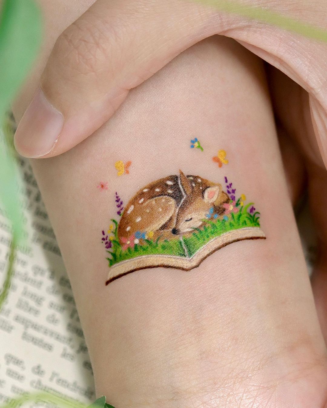 colorful book tattoo by ovenlee.tattoo